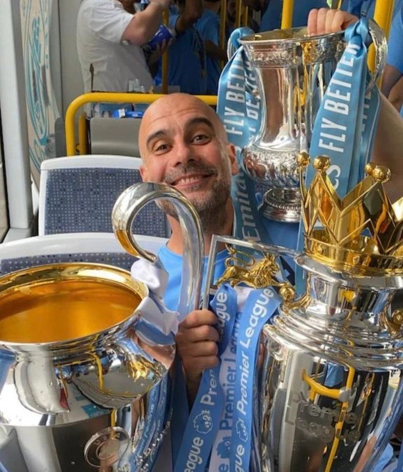 Pep Guardiola with the Champions League, Premier League and FA Cup